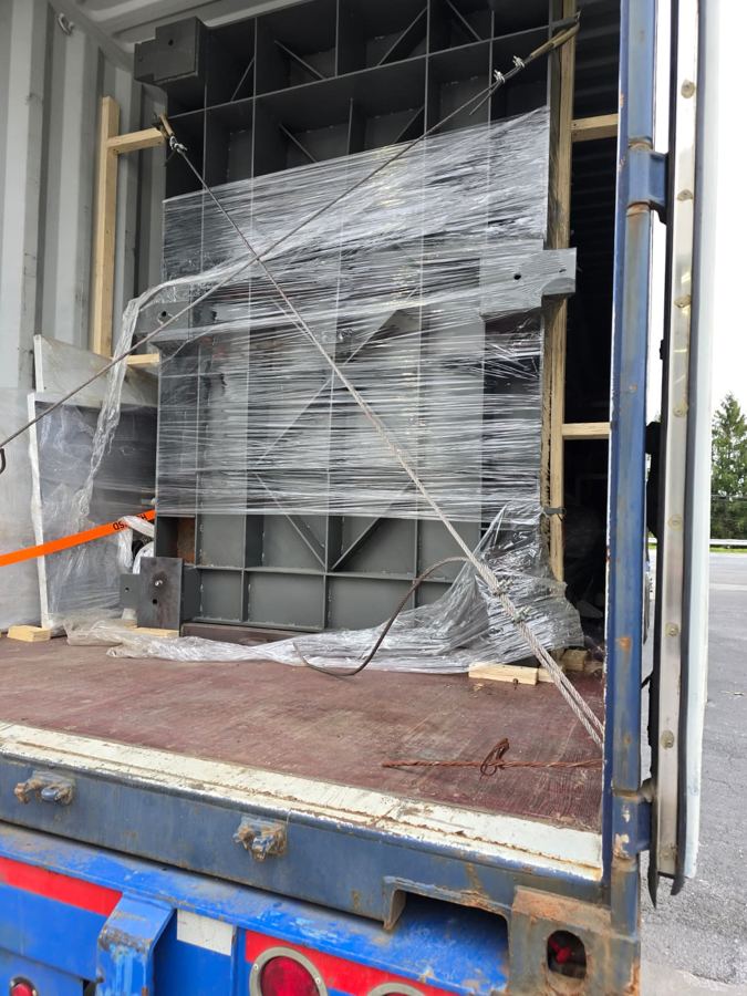Wrapped machine frame secured for transit